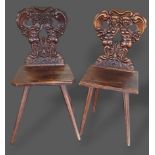 A near pair of 19th Century Italian hall chairs, each with a carved back above a panel set raised