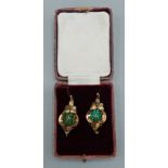A pair of Victorian yellow metal drop earrings, each set with green stones, 4.9gms, 3cms long