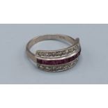 An 18ct gold ring set with a central row of Rubies and two rows of diamonds, 4.8gms, ring size T