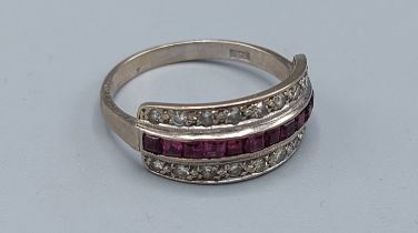 An 18ct gold ring set with a central row of Rubies and two rows of diamonds, 4.8gms, ring size T