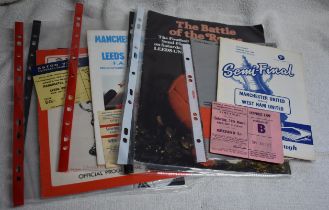 A collection of programmes and tickets featuring Manchester United or matches at Old Trafford in