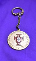 An engraved medal with chain issued by the Portuguese FA for the 1966 World Cup in England. Good