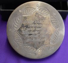 An engraved powder compact in a box presented to Sir Matt Busby for 25 years service to Manchester