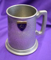 An engraved pewter mug presented to Manchester United players after their match against the Rest