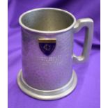 An engraved pewter mug presented to Manchester United players after their match against the Rest