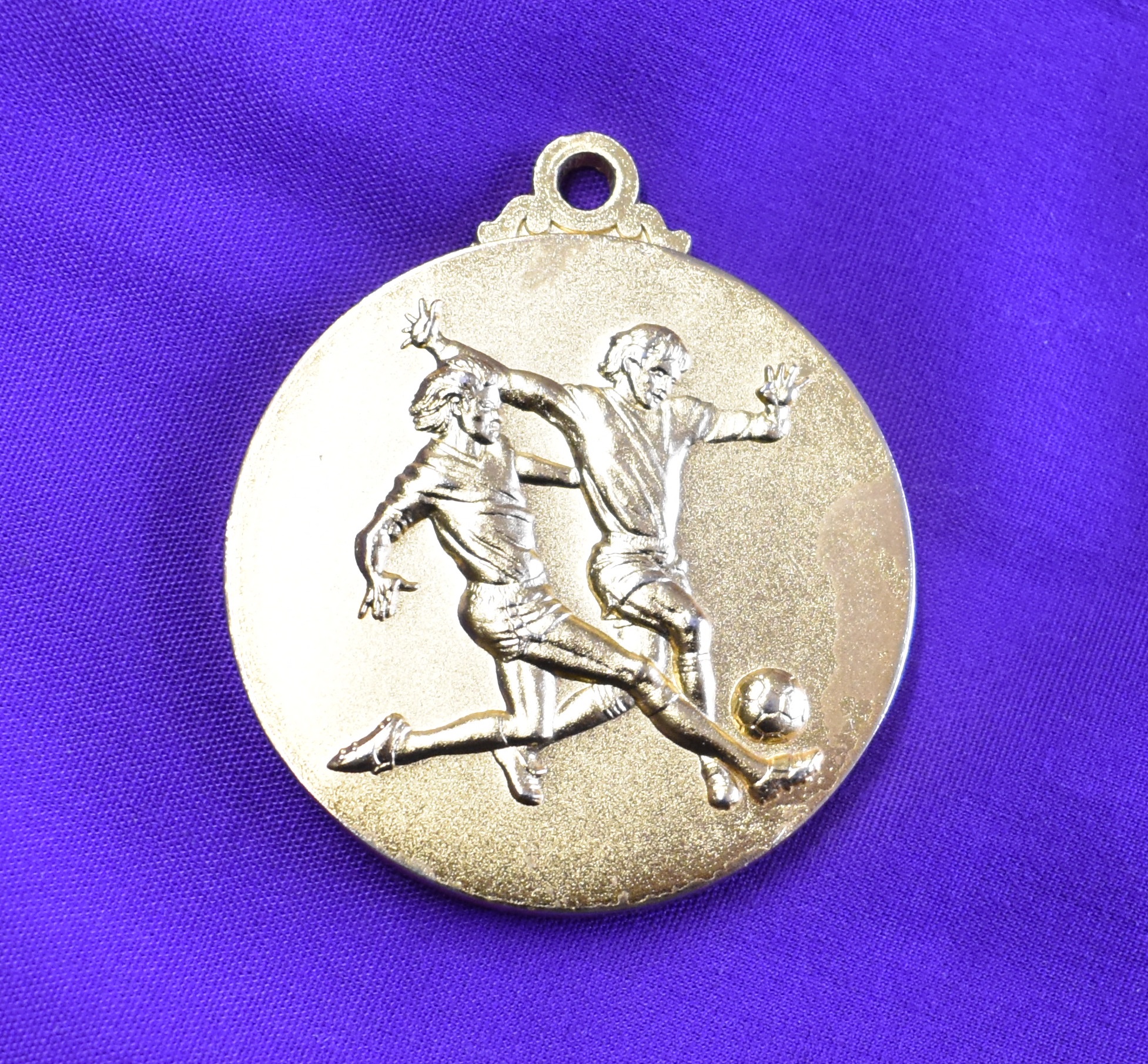 An engraved medal presented to a Manchester United player on the 20th July 1997 for the pre season