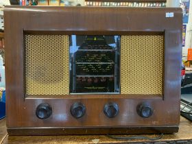 VINTAGE BUSH RADIO. A vintage bush AC valve radio receiver in a wooden casing, circa 1950. Still