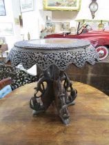 BURMESE CARVED SUPPER TABLE, ornate pierced foliate apron on 4 serpent leg supports, 57cm diameter