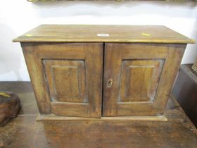 ANTIQUE TABLE TOP CABINET, twin paneled mahogany doors enclosing nest of 4 drawers, 30cm height by