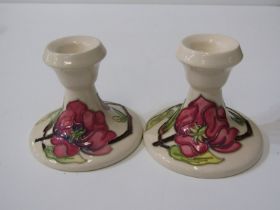 MOORCROFT, pair of "Magnolia" pattern cream ground dressing table candlesticks