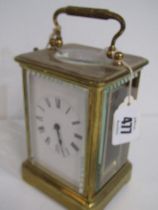 CARRIAGE CLOCK, brass cased carriage clock with bevelled glass panels, plain enamel face and key,