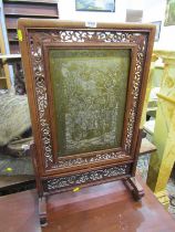 ORIENTAL FURNITURE, a pierced surround fire screen with inset brass engraved panel, 70cm height