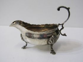 MID 18TH CENTURY SILVER SAUCE BOAT, with scroll handle and shell and hoof feet, London 1766, 175