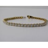 18ct YELLOW GOLD DIAMOND SET LINE BRACELET, complete with gemological science international