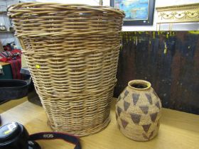 WICKER, a large wicker log basket, 59cm height; together with ethnic wicker pot, 26cm height