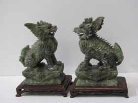 ORIENTAL CARVINGS, a pair of carved jade temple dogs on carved rectangular hardwood stand, 23cm