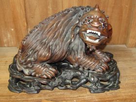 CHINESE CARVING, an antique carved cherry root sculpture of demon dog on ornate carved stand with