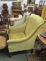 EARLY VICTORIAN MAHOGANY FRAMED WING ARMCHAIR with gold upholstery, original castors