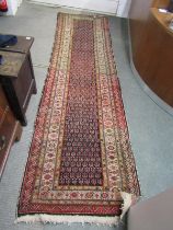 MIDDLE EASTERN RUNNER RUG, a hand knotted woollen rug with blue central medallion within 4 main