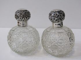 PAIR OF ANTIQUE CUT GLASS SPHERICAL SCENT BOTTLES, embossed silver caps