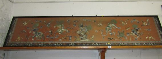 ORIENTAL EMBROIDERY, a large panoramic panel depicting dancing temple dogs and dragon in cloud