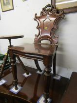 VICTORIAN MAHOGANY HALL SEAT, foliate carved shield back design with serpentine fronted seat