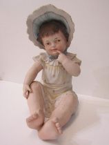 EDWARDIAN BISQUE PORCELAIN FIGURE, of seated child after Heubach, 30cm height