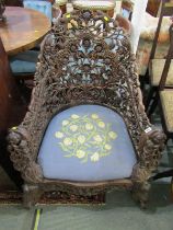 BURMESE, ornate carved and pierced tub armchair with animal mask armheads and serpentine fronted