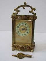 FRENCH BRASS BOUND CARRIAGE CLOCK with bevelled glass panels and foliate banded decoration, 12cm