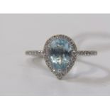 AQUAMARINE & DIAMOND CLUSTER RING, 18ct white gold ring set a pear shaped aquamarine within a