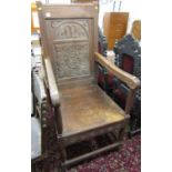 HEAVY CARVED ARMCHAIR, with carved panel back dated 1904 and rising seat