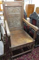HEAVY CARVED ARMCHAIR, with carved panel back dated 1904 and rising seat