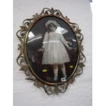 PAINTING ON GLASS, oval portrait of a Victorian girl 48cms in a brass foliate frame