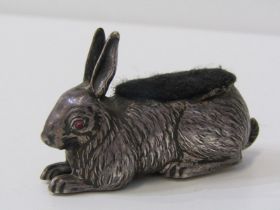 SILVER NOVELTY PIN CUSHION IN THE FORM OF A HARE, with red glass eyes, Birmingham HM 1907, 7cm