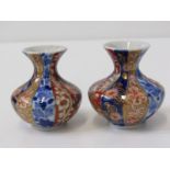 JAPANESE FUKAGAWA VASES, pair of miniature vases with alternate blue and red gilt decorated floral