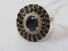 SAPPHIRE CLUSTER RING, 9ct yellow gold ring set a large oval sapphire, with a cluster of further