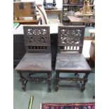 CARVED HALL CHAIRS, pair of oak framed solid seat hall chairs with pierced carved foliate back and