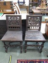 CARVED HALL CHAIRS, pair of oak framed solid seat hall chairs with pierced carved foliate back and