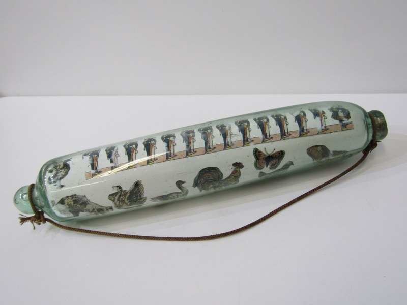 ANTIQUE GLASS, antique glass rolling pin, internally decorated with prints including military