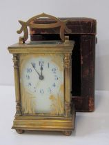 FRENCH BRASS CARRIAGE CLOCK with painted glass front panel in a pillar support case, in fitted