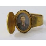 UNUSUAL HINGED LOCKET STYLE PORTRAIT BANGLE, in yellow metal, tests possibly high carat