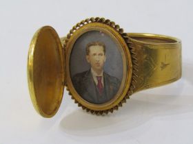 UNUSUAL HINGED LOCKET STYLE PORTRAIT BANGLE, in yellow metal, tests possibly high carat
