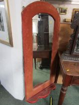 BEVEL EDGED WALL MIRROR, shaped mirror in an upholstered frame with lower shaped shelf, 138cm height