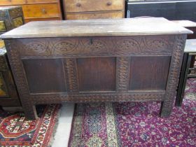 18th CENTURY OAK COFFER, with 3 panel front, carved frame and rising top, enclosing strap hinges and