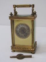 FRENCH BRASS CASED CARRIAGE CLOCK with silvered dial and Arabic numerals in stylised case, 12cm