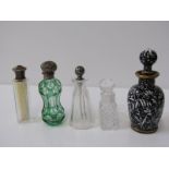 SCENT BOTTLES, 5 bottles including one with floral decoration on a black ground, 2 silver mounted