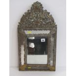 ANTIQUE BRASS MIRROR, bevel edged mirror in a foliate decorated frame in relief, 60cm height