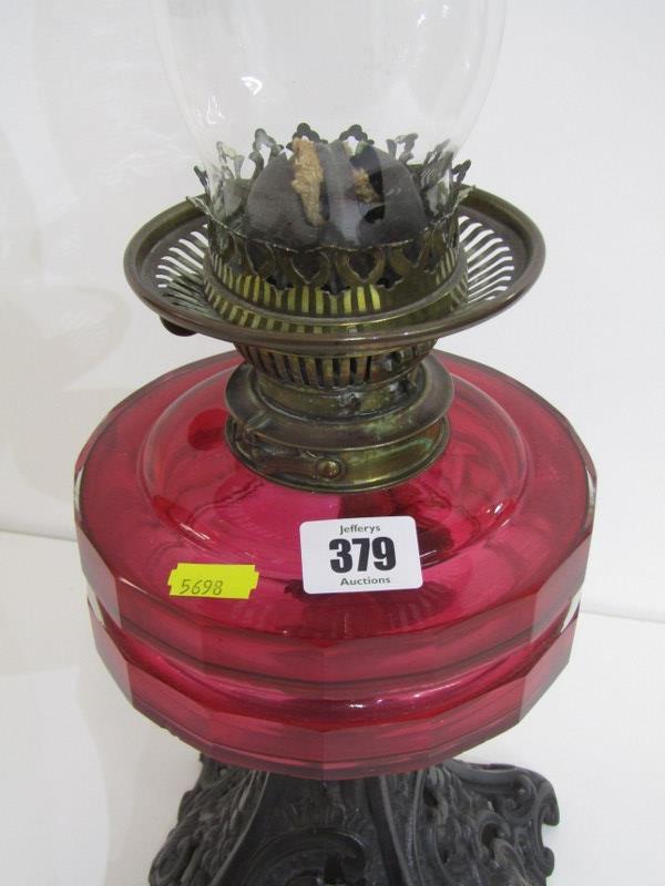 LATE VICTORIAN OIL LAMP, with cast iron foliate decorated base and red glass reservoir, 57cm - Image 2 of 3
