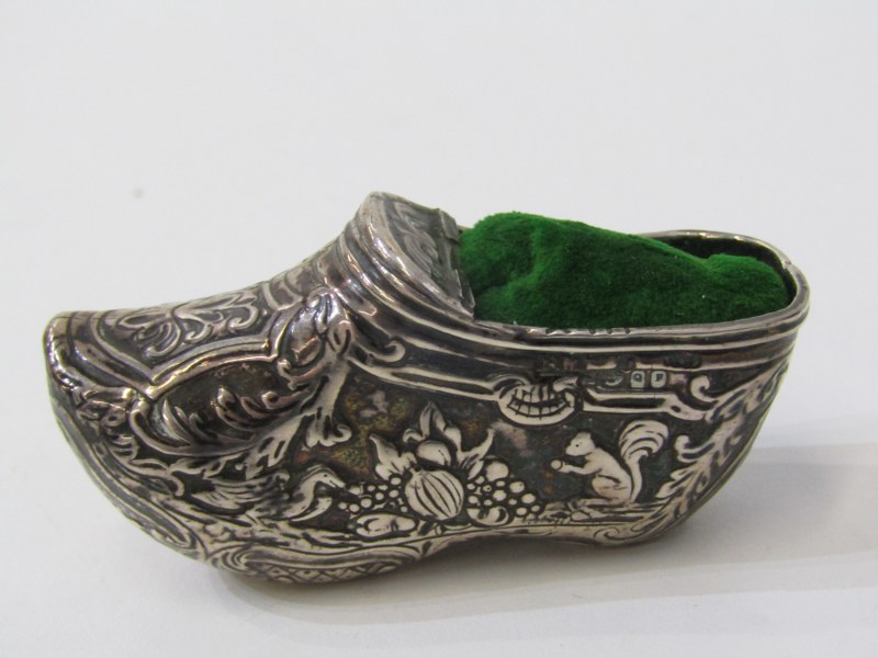 WHITE METAL NOVELTY PIN CUSHION in the form of a shoe, decorated with hunting scenes in relief