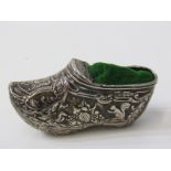 WHITE METAL NOVELTY PIN CUSHION in the form of a shoe, decorated with hunting scenes in relief